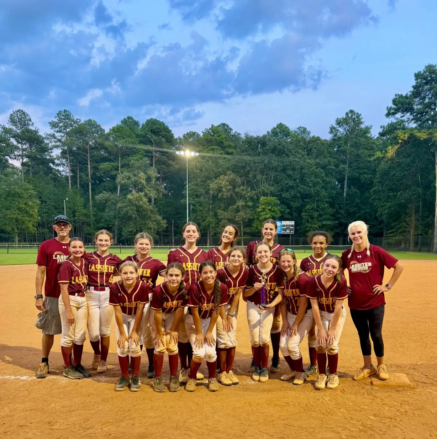 Lassiter Fastpitch softball team and coaches gathered together on the field